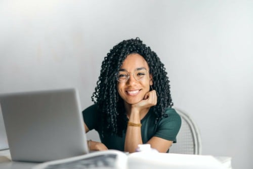 happy woman at laptop what can a virtual executive assistant do for me