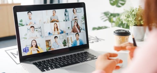 Laptop showing a video group call of virtual assistants